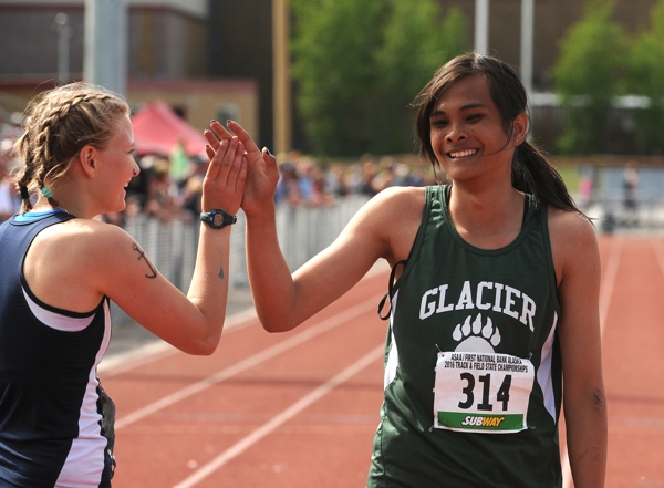 Ziza Shemet Pitcher of Homer and Ice Wangyot high-five after competing in the 200-meter sprint. (Bob Hallinen / Alaska Dispatch News)